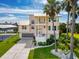 Beautiful multi-story home with lush landscaping, a metal roof, and a waterfront view at 3342 Turks Cap Dr, Hernando Beach, FL 34607