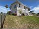 Side view of a two-story home with a screened porch and well-maintained lawn at 3342 Turks Cap Dr, Hernando Beach, FL 34607