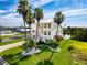 Well-maintained multi-story house with mature palm trees, waterfront access and manicured lawn at 3342 Turks Cap Dr, Hernando Beach, FL 34607