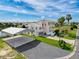 Charming home with a metal carport, lush landscaping, and a spacious driveway at 3342 Turks Cap Dr, Hernando Beach, FL 34607