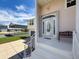 Inviting front porch with glass front door, bench seating, and an attached carport at 3342 Turks Cap Dr, Hernando Beach, FL 34607