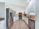 Bright kitchen features stainless steel appliances, tile backsplash, and white cabinetry at 3342 Turks Cap Dr, Hernando Beach, FL 34607