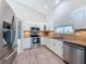 Bright kitchen features stainless steel appliances, tile backsplash, and white cabinetry at 3342 Turks Cap Dr, Hernando Beach, FL 34607