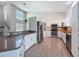 Open-concept kitchen with bar seating, stainless appliances, and bright white cabinets at 3342 Turks Cap Dr, Hernando Beach, FL 34607