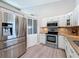 Modern kitchen with stainless steel appliances, granite countertops, and white cabinetry at 3342 Turks Cap Dr, Hernando Beach, FL 34607