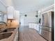 Kitchen features stainless appliances, bar seating, and light gray flooring at 3342 Turks Cap Dr, Hernando Beach, FL 34607