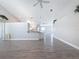 Open floor plan with wood laminate flooring, vaulted ceilings, and a breakfast bar at 3342 Turks Cap Dr, Hernando Beach, FL 34607
