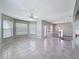 Bright open-plan living room featuring tile flooring, neutral walls, and staircase at 3342 Turks Cap Dr, Hernando Beach, FL 34607