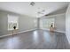 Spacious living room featuring light gray flooring, ceiling fan and large windows at 3342 Turks Cap Dr, Hernando Beach, FL 34607