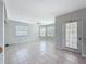 Bright open-plan living room featuring tile flooring, neutral walls and bay window at 3342 Turks Cap Dr, Hernando Beach, FL 34607