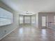 Bright open-plan living room featuring tile flooring, neutral walls and bay window at 3342 Turks Cap Dr, Hernando Beach, FL 34607