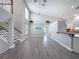 Inviting living area featuring wood laminate floors, an open staircase, and high ceilings at 3342 Turks Cap Dr, Hernando Beach, FL 34607