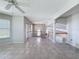 Bright open-plan living room featuring tile flooring, neutral walls, and staircase at 3342 Turks Cap Dr, Hernando Beach, FL 34607