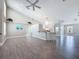 Spacious living area with an open floor plan, breakfast bar, wood laminate floors, and vaulted ceilings at 3342 Turks Cap Dr, Hernando Beach, FL 34607