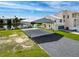 Exterior elevation showcasing covered parking with adjacent home featuring waterfront view at 3342 Turks Cap Dr, Hernando Beach, FL 34607