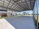 Spacious covered parking area with a concrete slab and metal roof, providing ample space for vehicles and storage at 3342 Turks Cap Dr, Hernando Beach, FL 34607