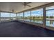 Enclosed outdoor carpeted patio with ceiling fans and views of the water at 3342 Turks Cap Dr, Hernando Beach, FL 34607