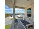 Charming porch swing with view of neighborhood streets and waterways at 3342 Turks Cap Dr, Hernando Beach, FL 34607