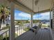Charming porch swing with view of neighborhood streets and waterways at 3342 Turks Cap Dr, Hernando Beach, FL 34607
