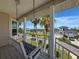 Charming porch swing with view of neighborhood streets and waterways at 3342 Turks Cap Dr, Hernando Beach, FL 34607