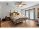 Spacious bedroom with a wooden bed frame and an adjacent bathroom with a closet at 34955 Blanton Rd, Dade City, FL 33523