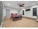 Spacious bedroom with tiled floors, ceiling fan, and natural light at 34955 Blanton Rd, Dade City, FL 33523