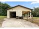 Detached garage with multiple bays and a covered area for additional parking at 34955 Blanton Rd, Dade City, FL 33523