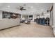 Open-concept living room featuring a modern fireplace, tile floors, and a ceiling fan at 34955 Blanton Rd, Dade City, FL 33523
