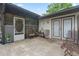 Cozy outdoor patio with neutral-colored stone pavers, patio furniture, potted plants, and access to the house at 34955 Blanton Rd, Dade City, FL 33523