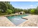Backyard area features a lovely in-ground pool and pool house at 34955 Blanton Rd, Dade City, FL 33523