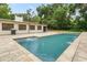 Large backyard area with pool, patio, and grill, perfect for entertaining at 34955 Blanton Rd, Dade City, FL 33523