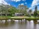 Aerial view of property overlooking a tranquil lake at 3545 Landale Dr, Holiday, FL 34691