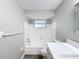 Bathroom with white tiled shower and vanity at 3545 Landale Dr, Holiday, FL 34691