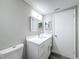 Modern bathroom features white vanity with sleek faucet and ample storage at 3545 Landale Dr, Holiday, FL 34691