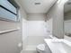 Bathroom featuring new vanity, lighting, and shower-tub combo at 3545 Landale Dr, Holiday, FL 34691