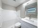 Bathroom featuring new vanity, lighting, and shower-tub combo at 3545 Landale Dr, Holiday, FL 34691