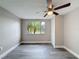 Empty bedroom shows natural light from the window and neutral walls at 3545 Landale Dr, Holiday, FL 34691