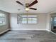 Empty Bedroom with hardwood floors, fan and two windows with views of the canal at 3545 Landale Dr, Holiday, FL 34691