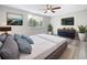 Bright bedroom with a ceiling fan, large window, dresser, and light grey wood look flooring at 3545 Landale Dr, Holiday, FL 34691