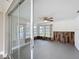 Bonus room featuring a ceiling fan, slider, and accent wall at 3545 Landale Dr, Holiday, FL 34691