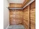 Walk-in closet with custom cedar plank walls and new shelving at 3545 Landale Dr, Holiday, FL 34691