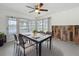 Dining area with table and seating featuring water views and sliding doors at 3545 Landale Dr, Holiday, FL 34691