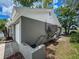 Home exterior showing siding, yard, and outdoor air conditioning unit at 3545 Landale Dr, Holiday, FL 34691