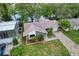 Aerial view of a single Gathering home with a well-maintained lawn and partial water view in the back at 3545 Landale Dr, Holiday, FL 34691