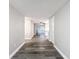 Hallway with hard surface floors leading to the kitchen and living area at 3545 Landale Dr, Holiday, FL 34691