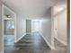 Hallway with gray vinyl wood flooring and neutral paint at 3545 Landale Dr, Holiday, FL 34691