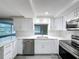 Updated kitchen featuring white cabinets, stainless steel appliances and quartz countertops at 3545 Landale Dr, Holiday, FL 34691