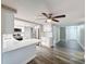 Bright kitchen with stainless steel appliances, white cabinetry, and eat-in bar at 3545 Landale Dr, Holiday, FL 34691