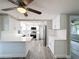 Modern kitchen featuring white cabinets, granite countertops, and stainless steel appliances at 3545 Landale Dr, Holiday, FL 34691