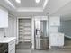 Updated kitchen with a stainless refrigerator and a large pantry at 3545 Landale Dr, Holiday, FL 34691